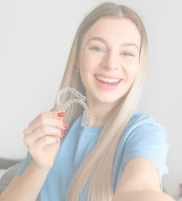 Patient holding clear aligners